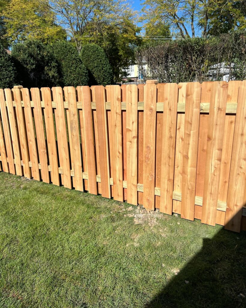 Wood fence in a backyard of a house